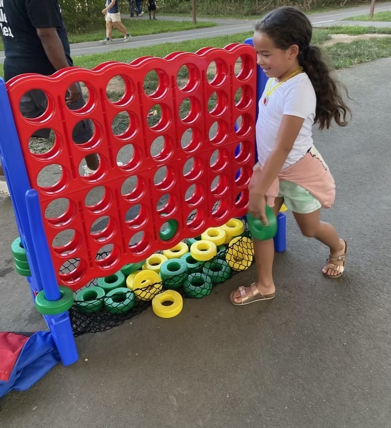 girl playing with connect 4 Home